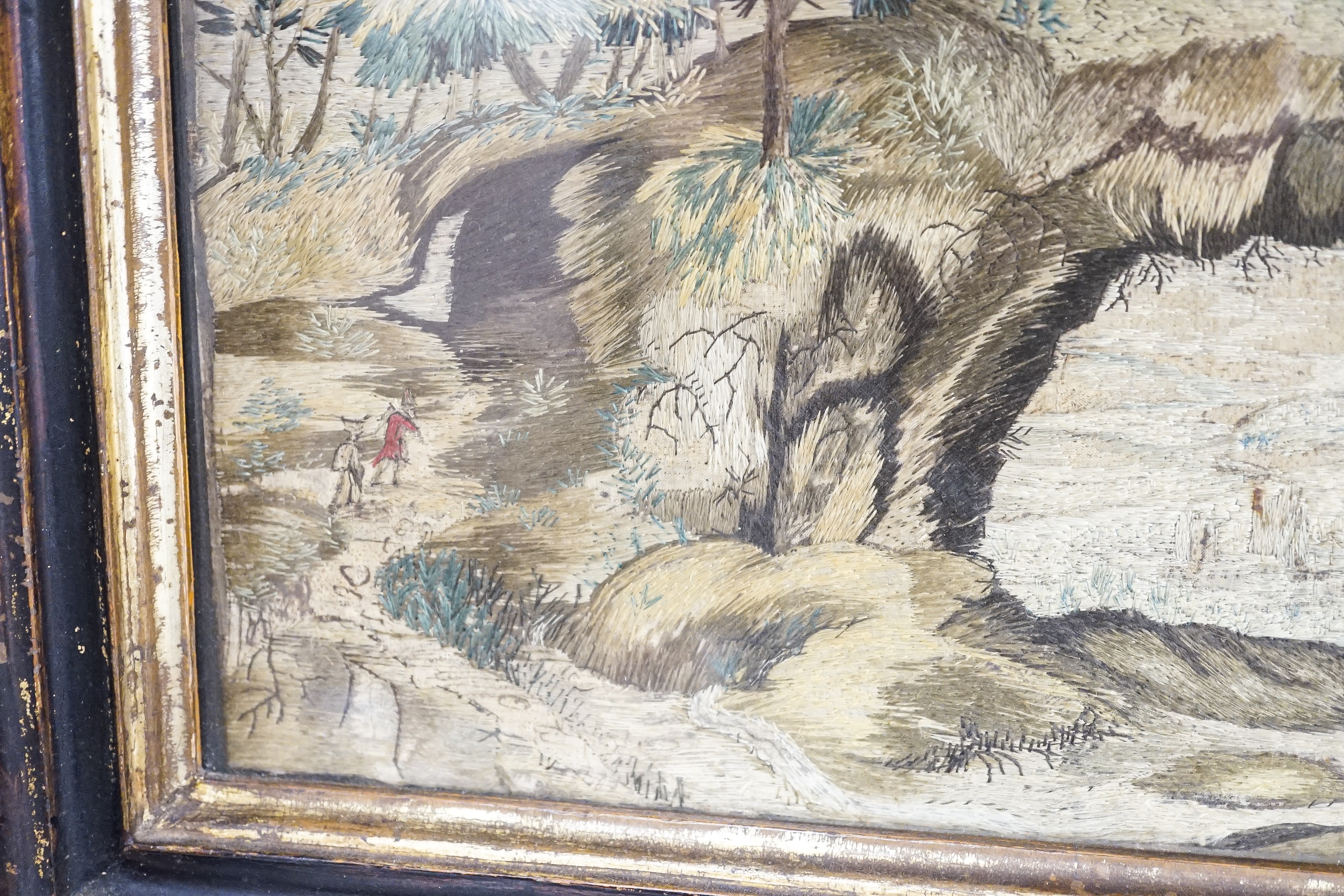 A pair of 18th century wool and silkwork pictures in ebonised frames, 26 cms high x 22 cms wide.